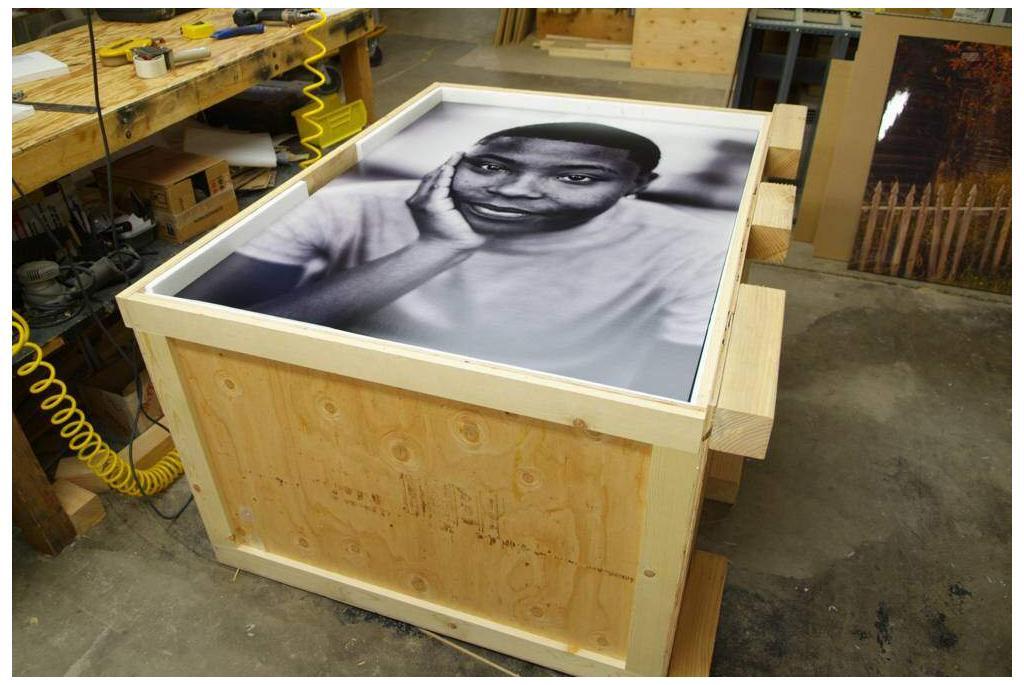 black and white painting of a man placed on a custom crate