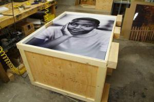 black and white painting of a man placed on a custom crate